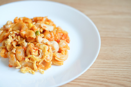 macaroni pasta in tomato sauce on a wooden tableの写真素材
