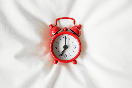 Clock on the bed in the morningの写真素材