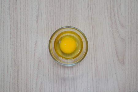 Close-up view of raw chicken eggs on wooden backgroundの写真素材