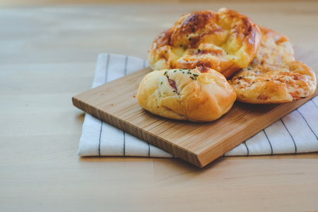 Homemade breads or bun on wood background, breakfast foodの写真素材