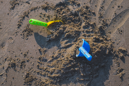 Vacation image of children's beach toys on the sandの写真素材