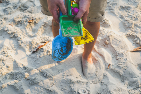 Vacation image of children's beach toys on the sandの写真素材