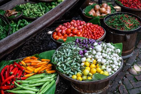 fresh vegetable on a market place colorful eggplants, chili, tomatoes, onion , saladの写真素材