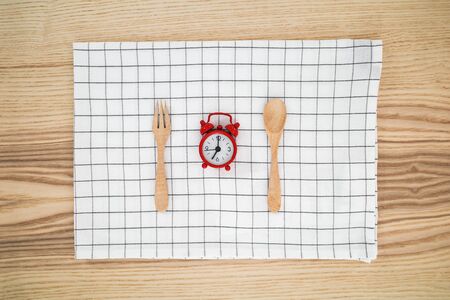 Meal time with alarm clock for breakfast , healthy food concept on table background