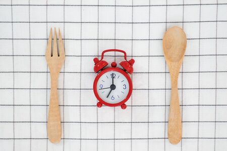 Meal time with alarm clock for breakfast , healthy food concept on table background