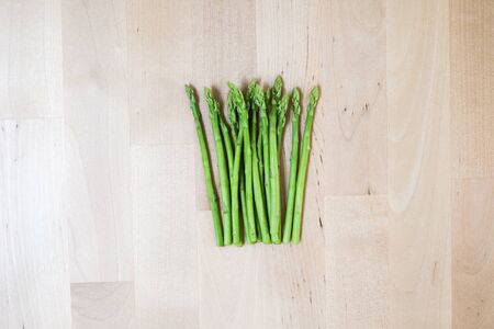 fresh green asparagus on wooden background, top viewの写真素材