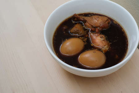 stewed eggs or eggs and chicken with spices in brown sauce traditional Thai foodの写真素材