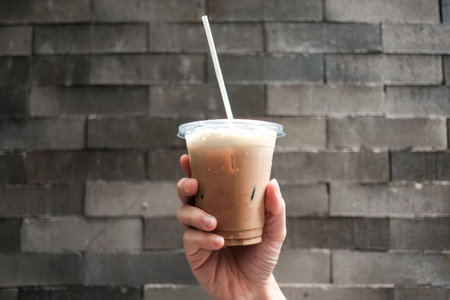 Iced coffee in plastic glass at cafe for take awayの写真素材