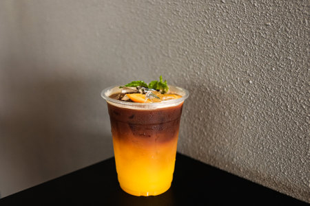 iced coffee and sea, Iced black coffee americano in take away cup (plastic glass) on the beach backgroundの写真素材