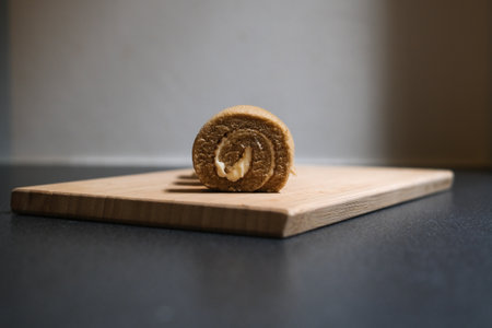Coffee roll cake on the wooden cutting board, Selective Focus.の写真素材