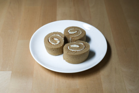 Coffee roll cake on white plate, Selective Focus.の写真素材