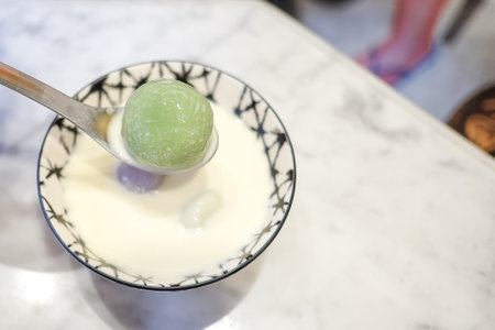 (Bua Loi, or Bua Loy) is a popular Thai dessert colorful chewy,  balls made from sticky rice flour in coconut milk in ceramic bowlの写真素材