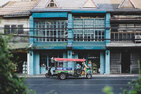 CHINATOWN, BANGKOK, THAILAND - 7 FEB 2023: Tuk tuk taxi parked near street market in Chinatown on Yaowarat road, the main street of China town.のeditorial素材