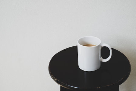 White cup of hot coffee on wooden table, soft focus.