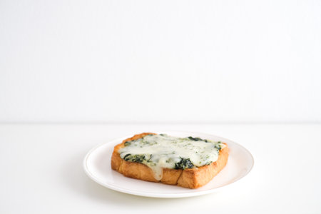 Spinach and cheese bread on a white plate.の写真素材