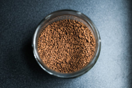 Open jar of instant coffee on table, top view, close-up, selective focus.の写真素材
