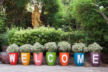 word WELCOME and goddess Kyun Yin satatue の写真素材