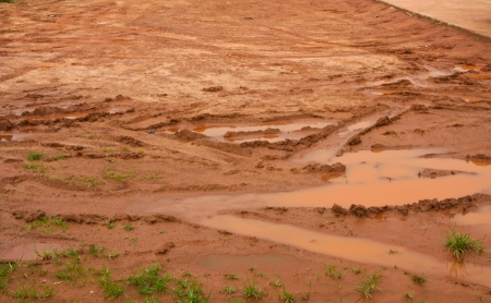 Car wheel track on dirty mud.