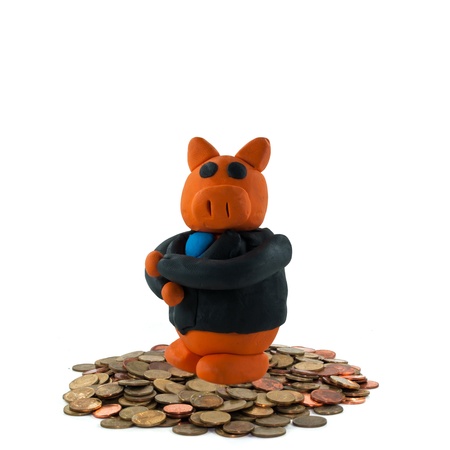 Businessman pig on coin on white backgroundの写真素材