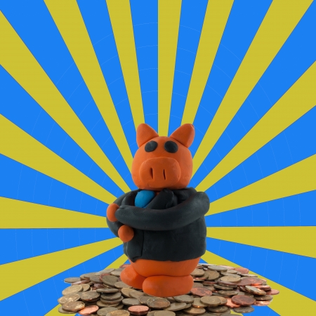 Businessman pig on coin on ray backgroundの写真素材
