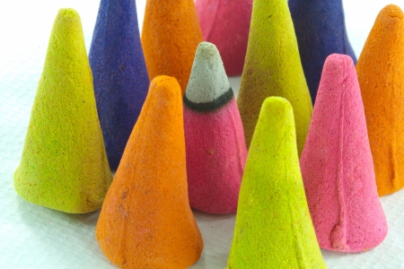 Colorful incense cone on white isolated background with burn by fire incense coneの写真素材