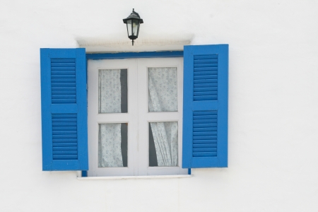 blue windows and black lantern on white wallの写真素材