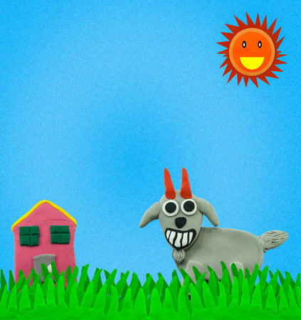Happy Goat on grass field and blue sky made from plasticineの写真素材