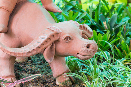 brown clay buffalo in gardenの写真素材