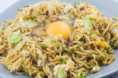 yakisoba with raw egg on plateの写真素材