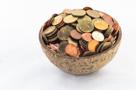 Thai Bath Satang money in half coconut shell on white background in concept saving moneyの写真素材