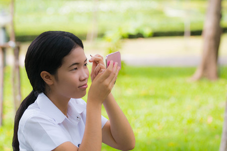 Beauty asian Student Makeup eyebrown in green parkの写真素材