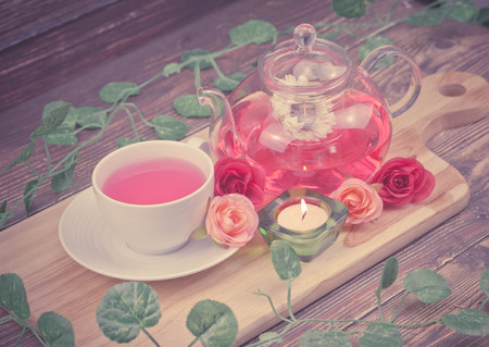 pot and cup of Rose tea on wood brown backgroundの写真素材