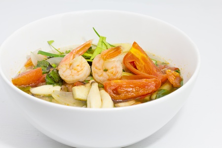 Tom Yum Goong or spicy tom yum soup with shrimp. Thai popular food menu, contained in bowl.