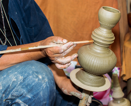 man showing carve clay for make textureの写真素材