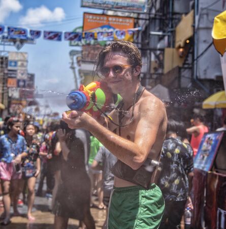 Bangkok, Thailand - April 13, 2018 : Tourist happiness fighting with water gun on the second day of water festival in Khao San Road, Let's play with soaked together on Songkran in Bangkokのeditorial素材