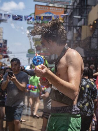 Bangkok, Thailand - April 13, 2018 : Tourist happiness fighting with water gun on the second day of water festival in Khao San Road, Let's play with soaked together on Songkran in Bangkokのeditorial素材