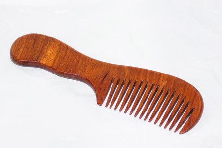 Comb made of wood on a white background.の写真素材