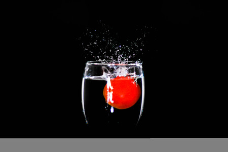 Tomatoes falling waterの写真素材