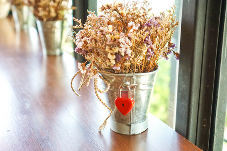 Key red heart on a wooden table, the concept of love and Valentine's Day.