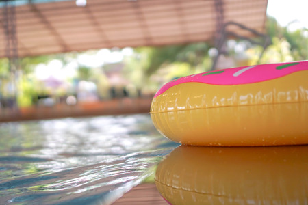 Swim ring floating on blue water with an airy wave reflection in the water.の写真素材