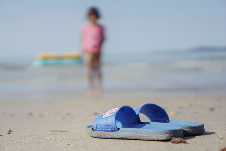 Blue shoes on the beach.の写真素材
