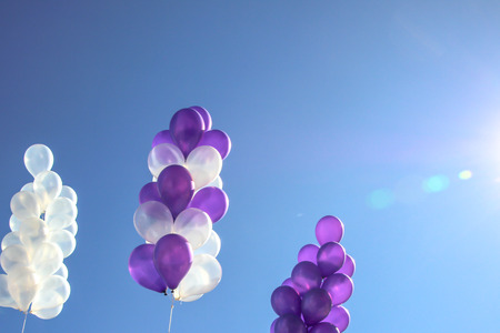 White and purple balloons on the sky background.の写真素材