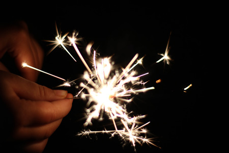 Children are playing fireworks as a beautiful light.の写真素材