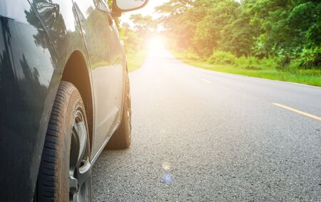 The car parked on the roadside with trees on the side of the road and the strength of the mind....
