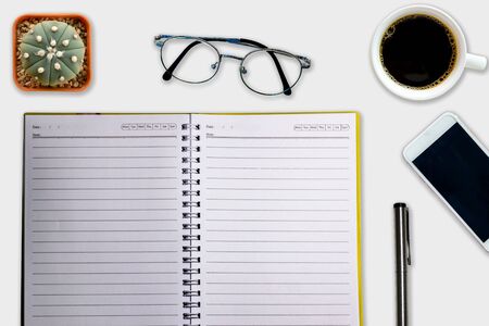 Office desk notebook  pen with accessories and coffee cups Top view with copy space.の写真素材