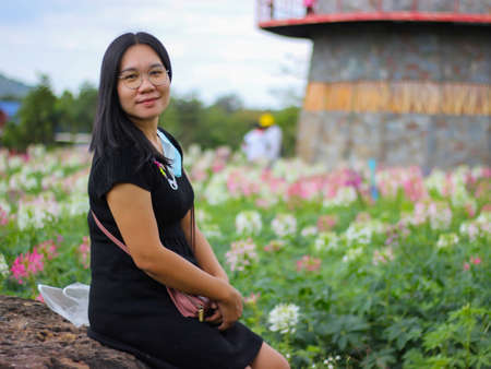 Asian woman in the flower garden touring the cosmos garden