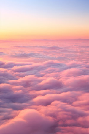 Aerial view of Beautiful sunrise sky above clouds or fog with dramatic light at dawn.の素材