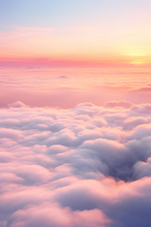 Aerial view of Beautiful sunrise sky above clouds or fog with dramatic light at dawn.の素材