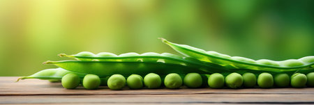Green pea pod, green peas on the wooden floor with natural bokeh background.の素材