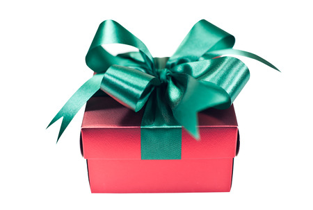 Red Christmas giftbox tied with lime green shimmering ribbonの写真素材